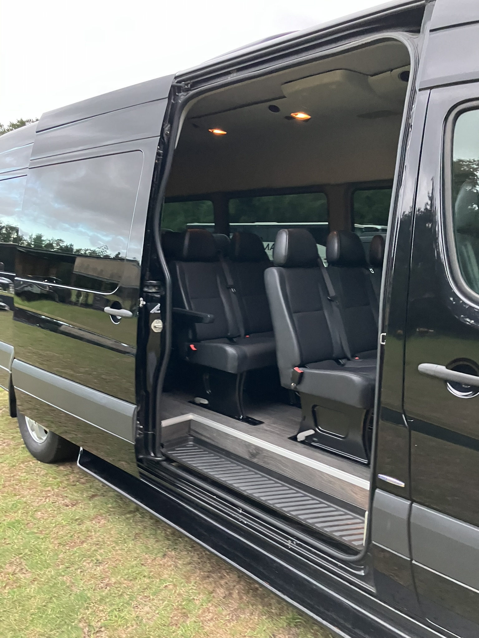 14-Passenger Mercedes Sprinter with Passenger Entry Door Open showing the passenger Interior