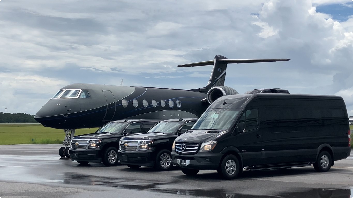 FTS Black Car Fleet Parked next to an Executive jet, Displaying the multiple vehicle options available. The image includes SUV's, Sprinters and Mini Buses