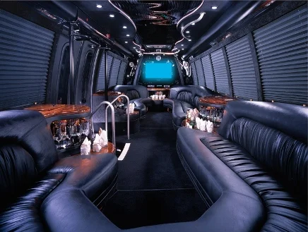 Luxury limousine interior with elegant lighting, plush seating, and modern entertainment features.