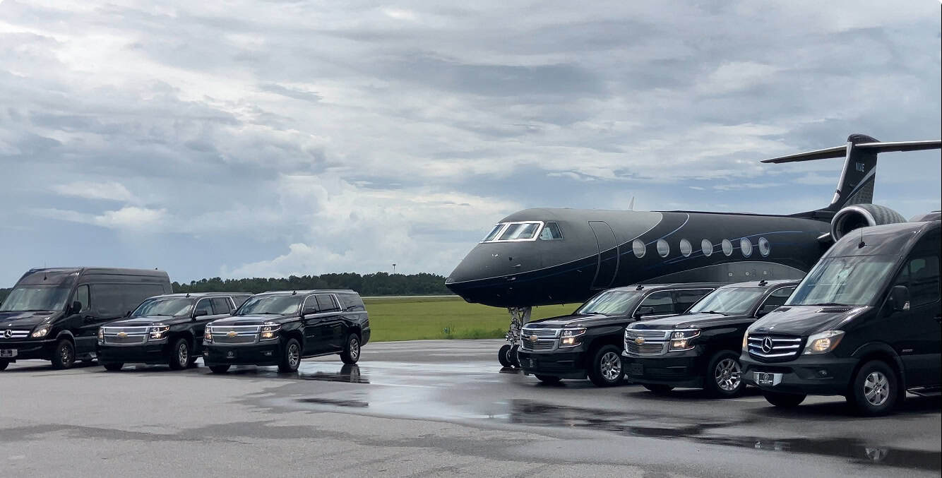 Luxury Chevrolet Suburban SUVs and Mercedes Sprinter executive vans parked beside a private jet, representing premium private airport black car service.