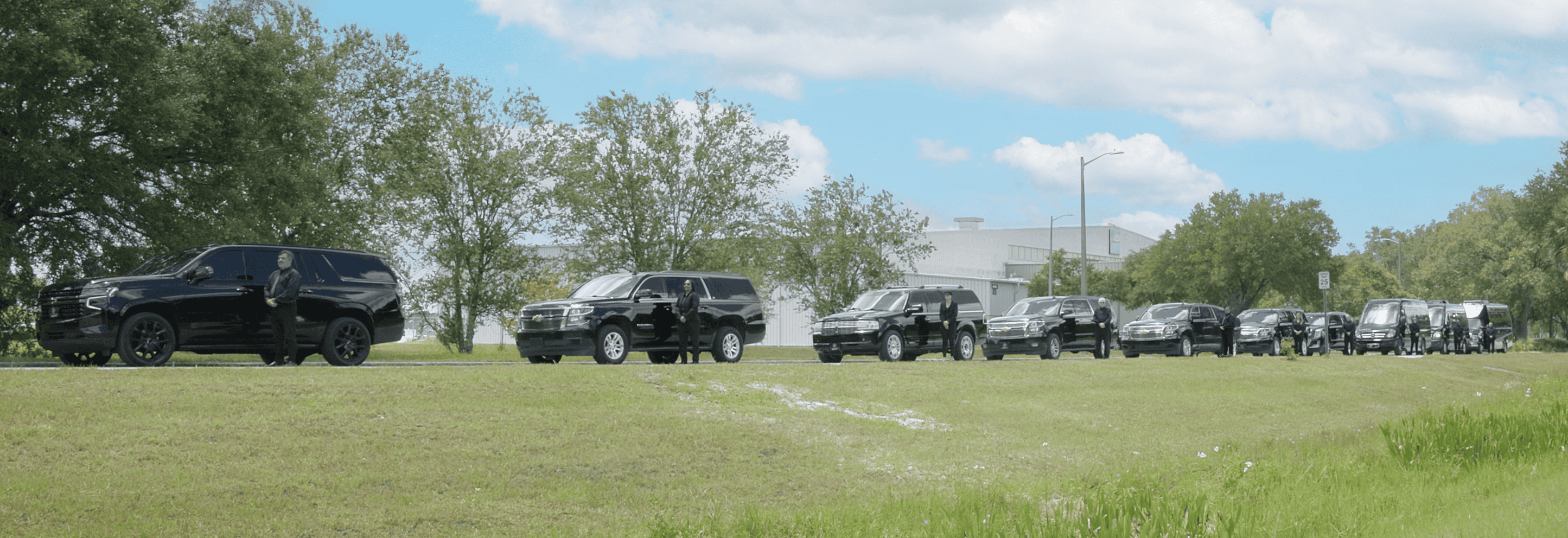 FTS Limousine chauffeurs stand beside luxury SUVs, executive vans, and shuttle vehicles staged for corporate transportation in Gainesville, Florida.