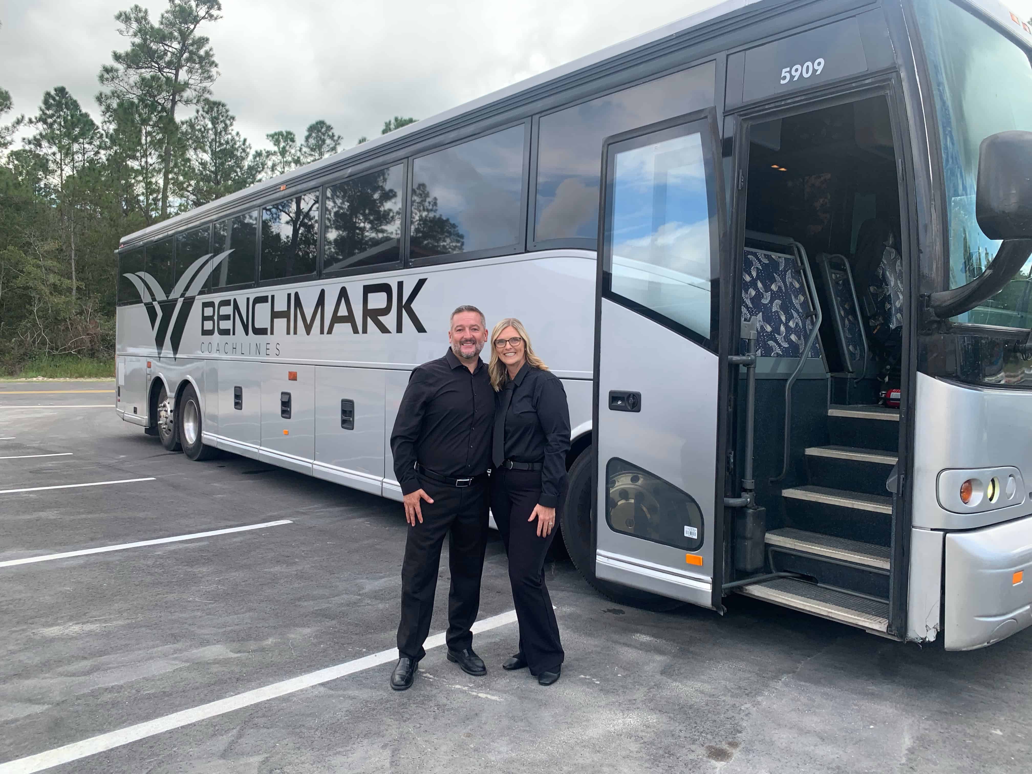 Benchmark Coachlines driver and FTS Limousine owner next to charter bus at corporate event with 2,000 guests – Florida luxury transportation