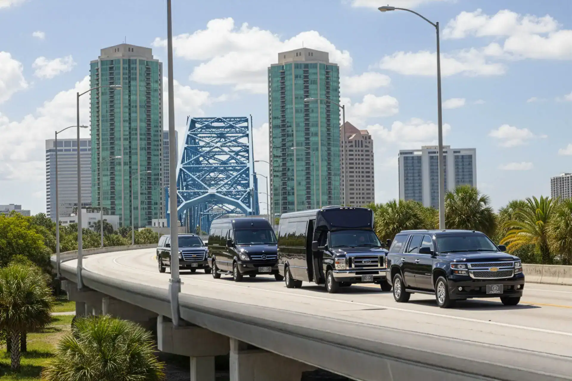 FTS Limousine convoy of black luxury vehicles crossing Main Street Bridge in downtown Jacksonville Florida.