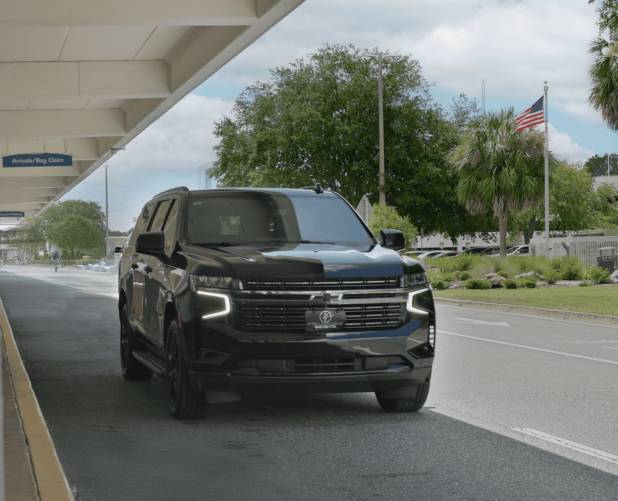 Black Suburban SUV arriving curbside at Gainesville Regional Airport in Gainesville Florida.
