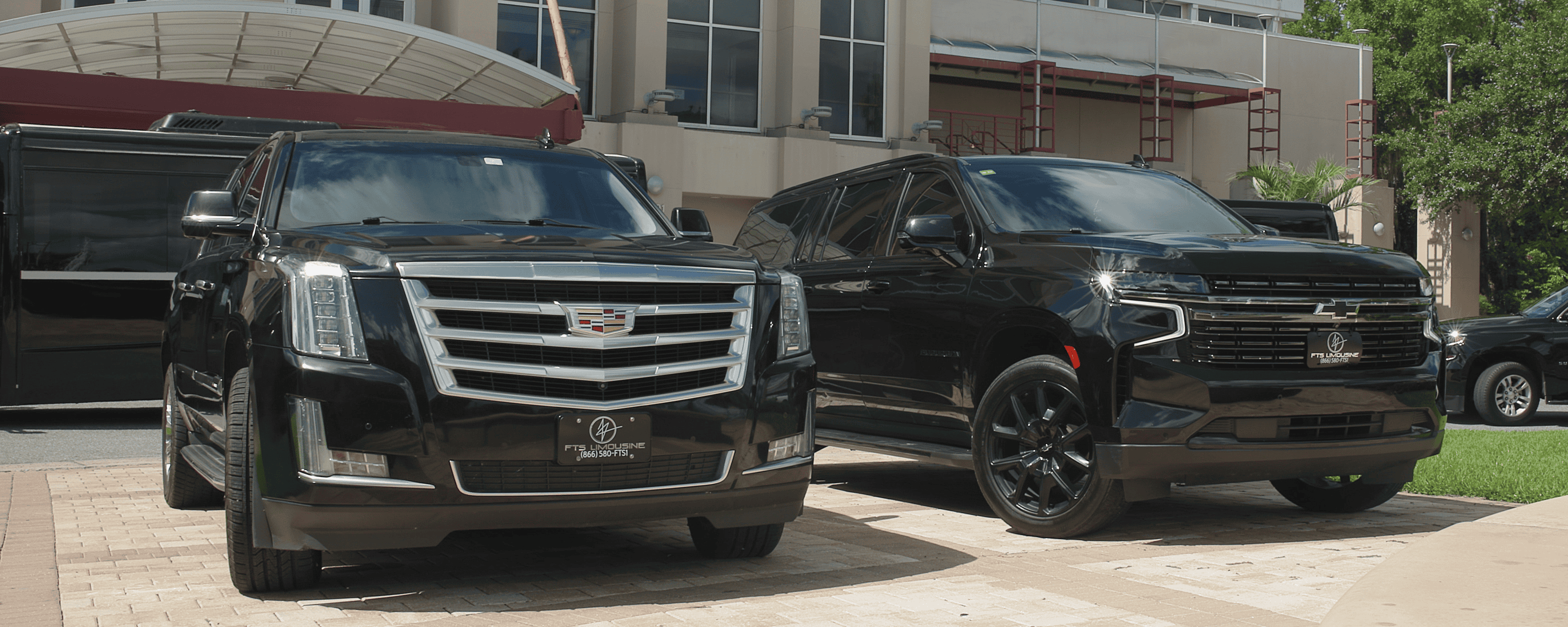 Two luxury SUVs parked outside the Curtis M. Phillips Center for the Performing Arts in Gainesville, FL – Black car and limousine service