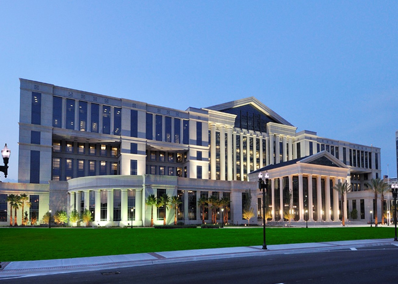 Duval County Courthouse in Jacksonville Florida at sunset with building lights illuminated.
