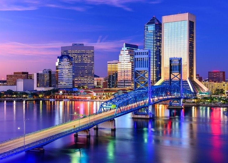 Jacksonville downtown bridge at night with city skyline in the background.