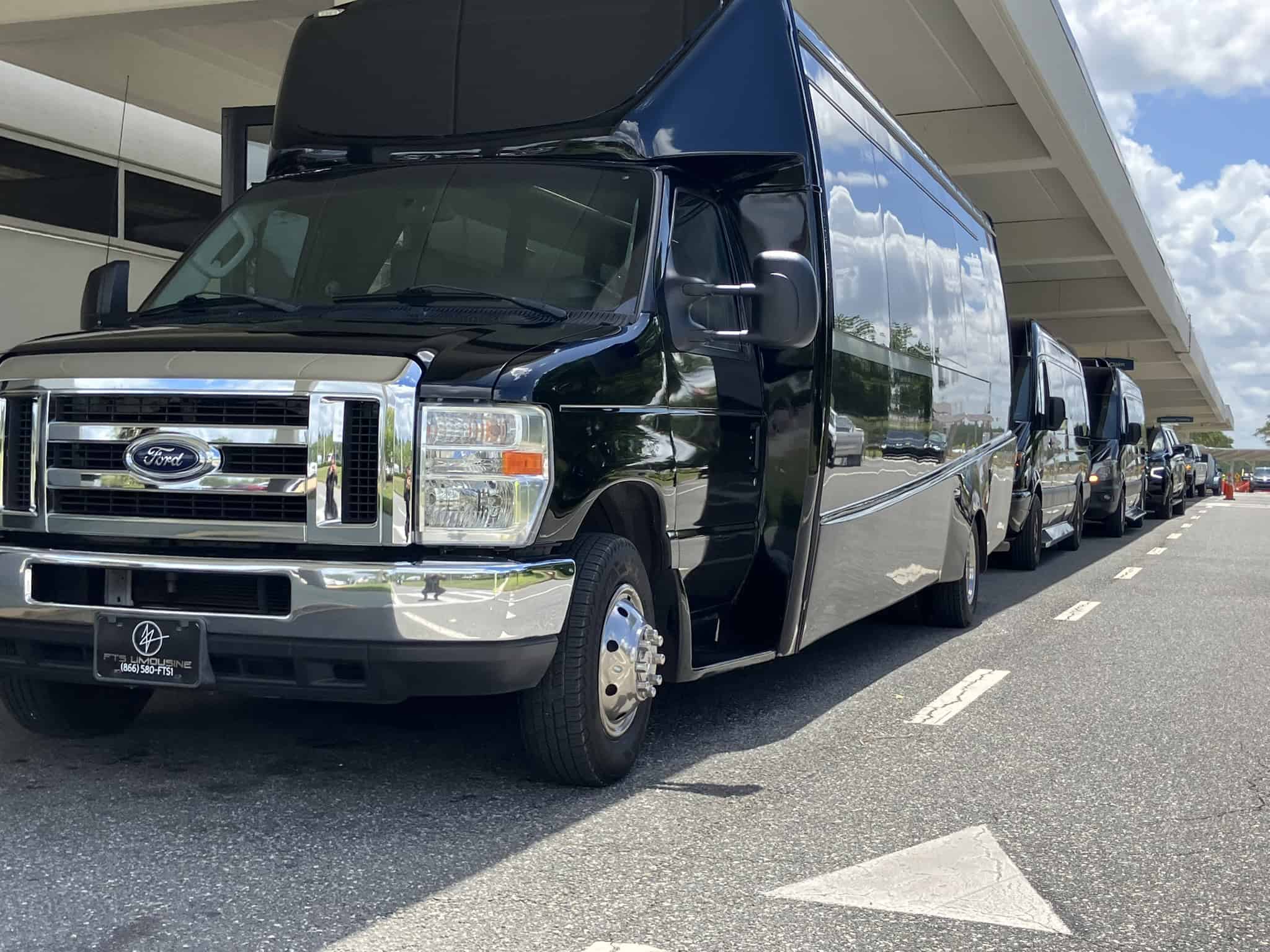 FTS Limousine executive shuttle buses, Mercedes Sprinter vans, and luxury SUVs providing coordinated passenger pickup at Gainesville Regional Airport (GNV).