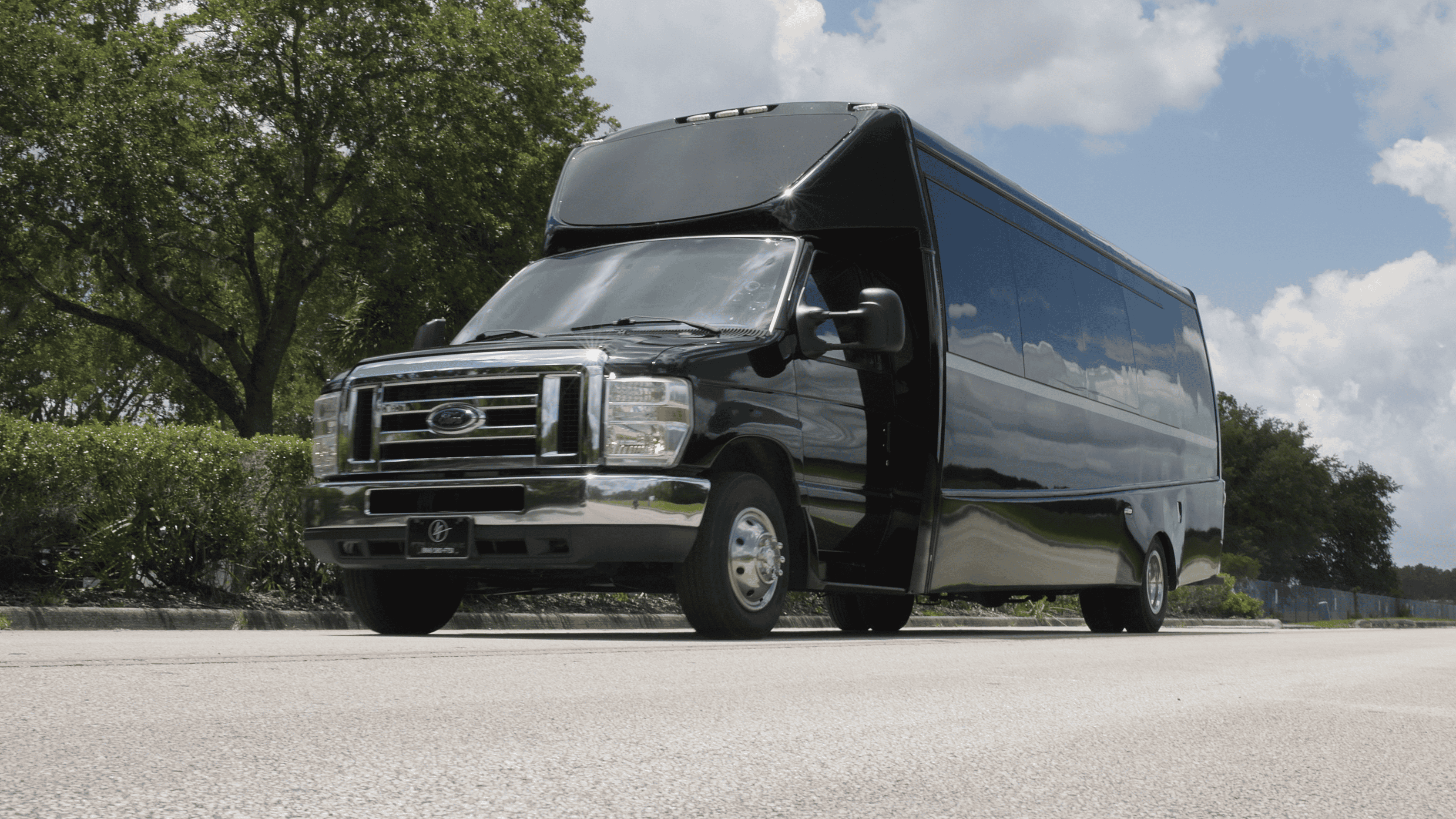 Luxury executive shuttle bus providing private airport transportation outside a private airport terminal