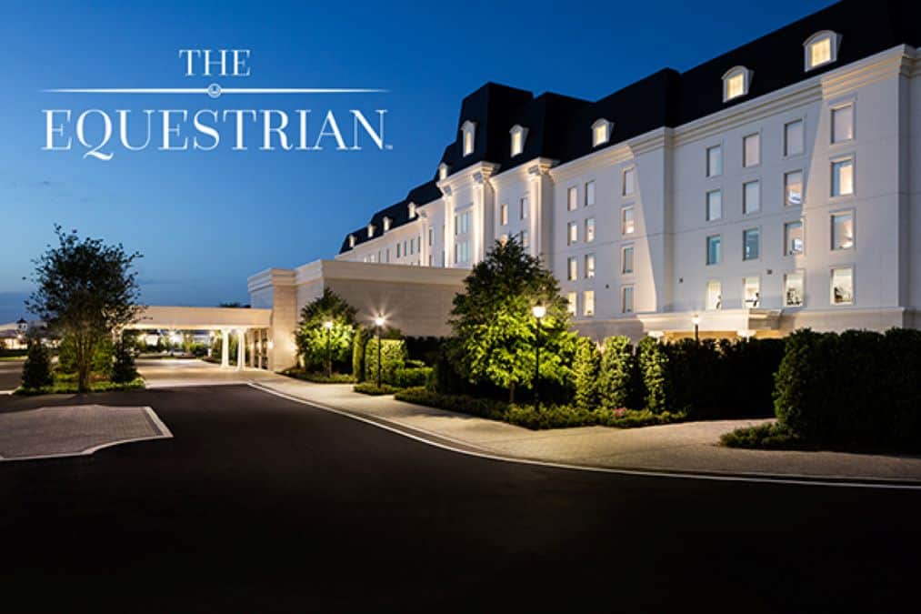 Sunset view of The Equestrian Hotel at the World Equestrian Center in Ocala, Florida with its illuminated exterior overlooking the equestrian grounds.