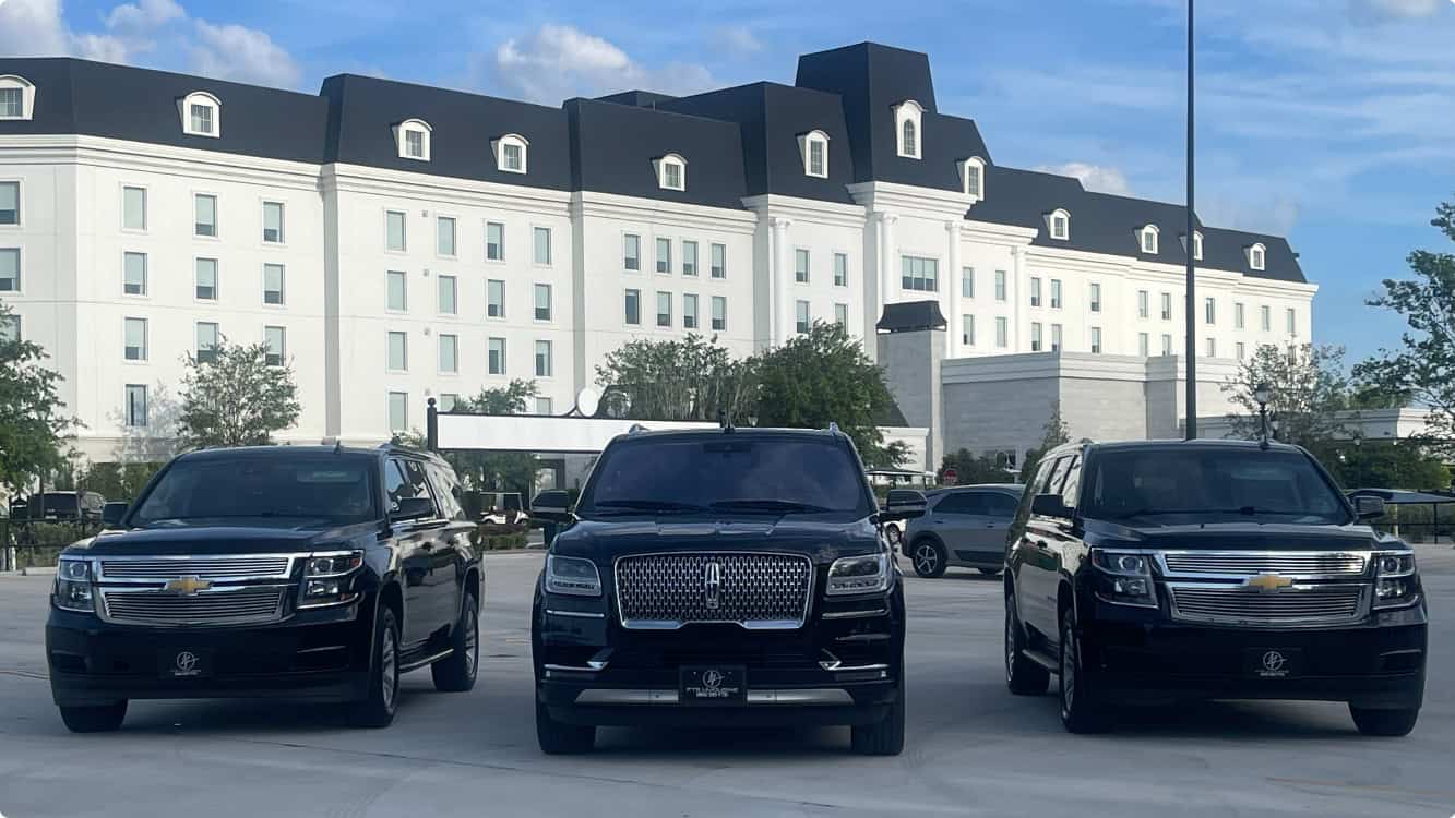 Three luxury SUVs parked outside The Equestrian Hotel at the World Equestrian Center in Ocala, Florida.